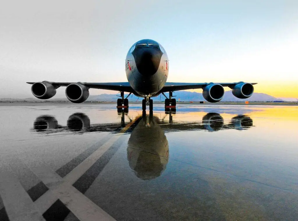 A large jet airplane on the tarmac with its wheels down.