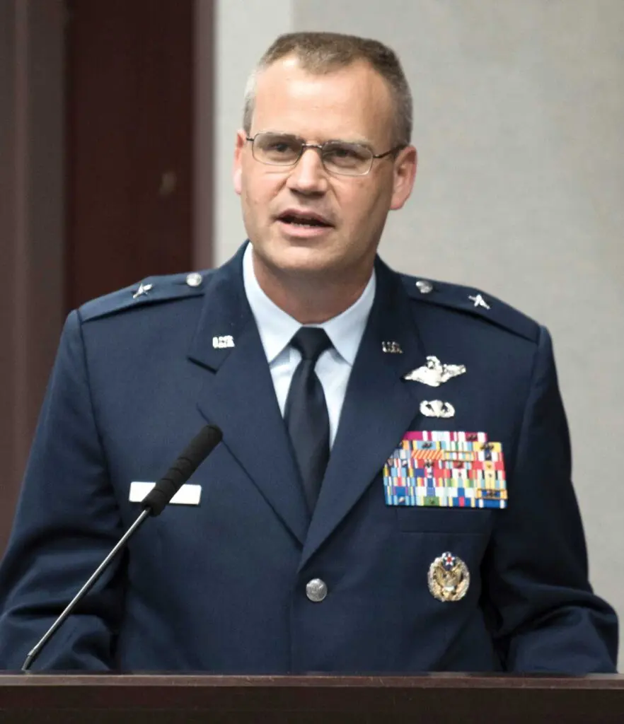 A man in military uniform standing at a podium.