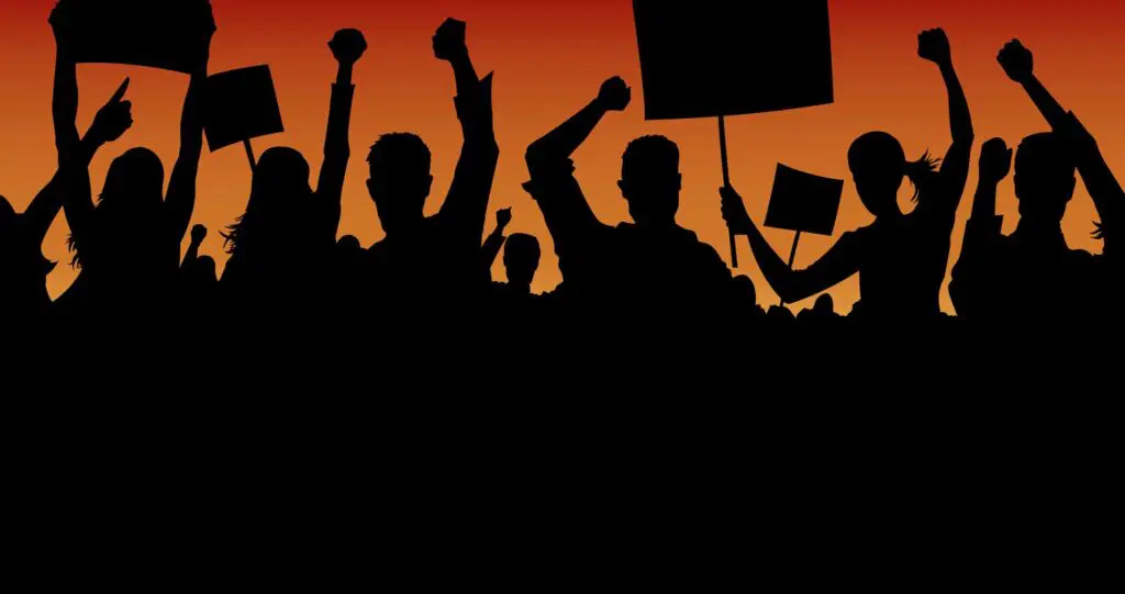 A group of people holding up signs and protesting.