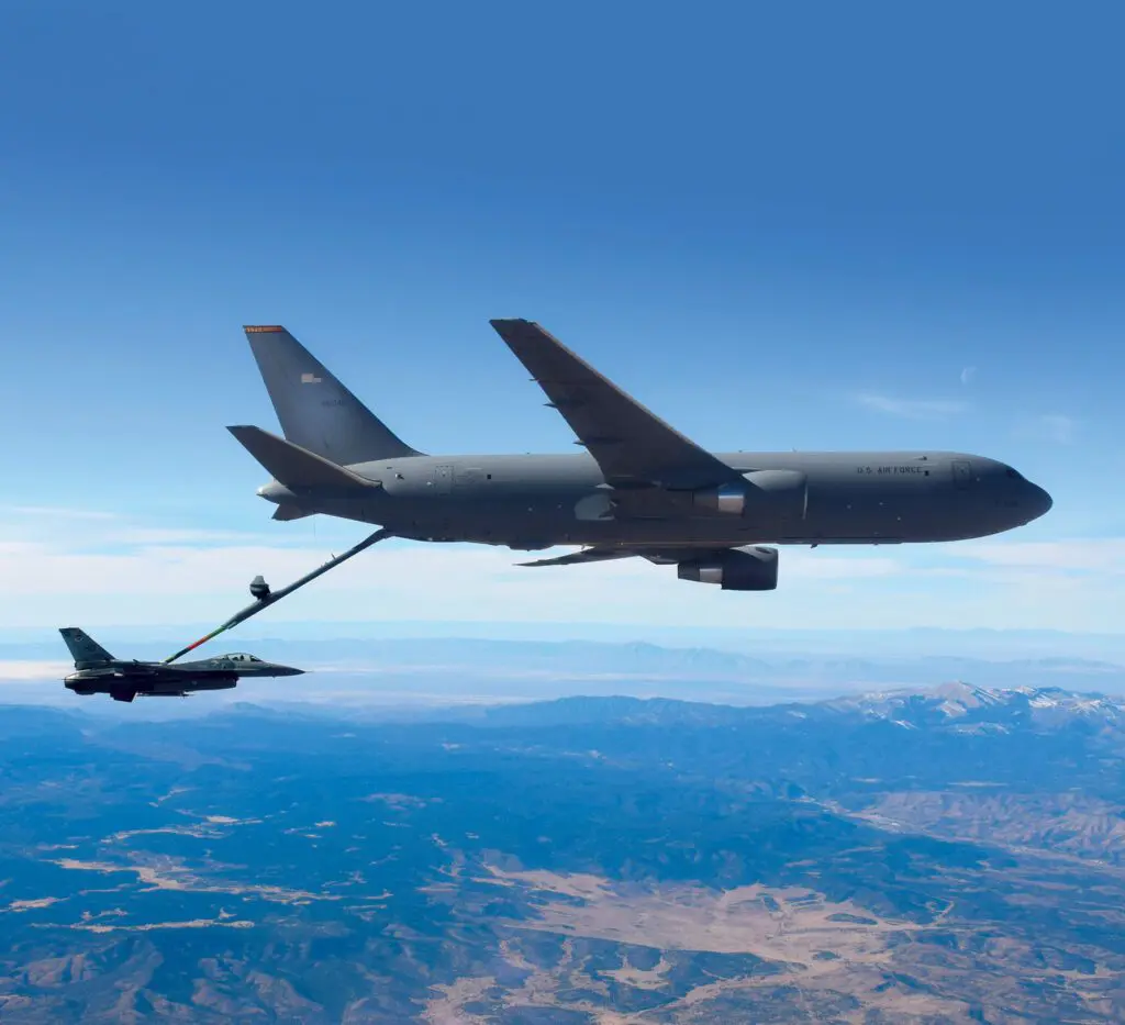 A plane flying in the sky with another plane on it