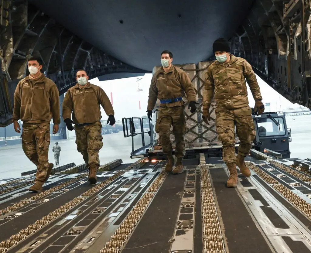 A group of soldiers walking on the ground.