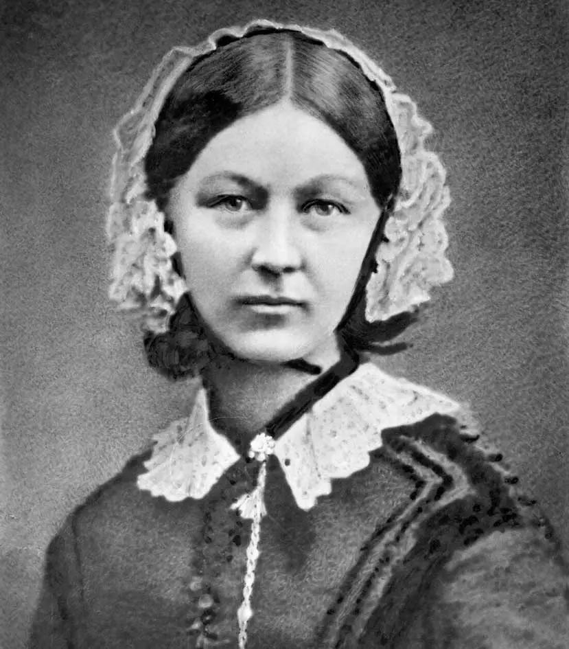 A black and white photo of a woman in a dress.