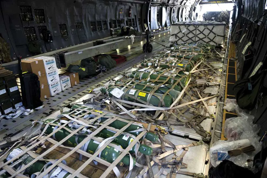 A large cargo plane with many tanks on it.