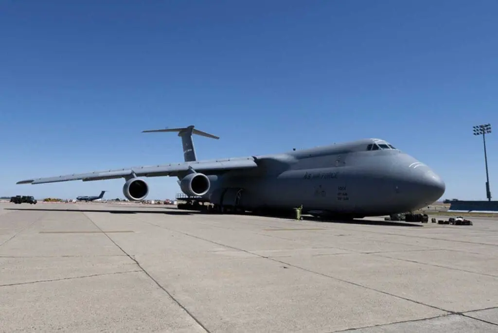 A large airplane sitting on top of an airport runway.