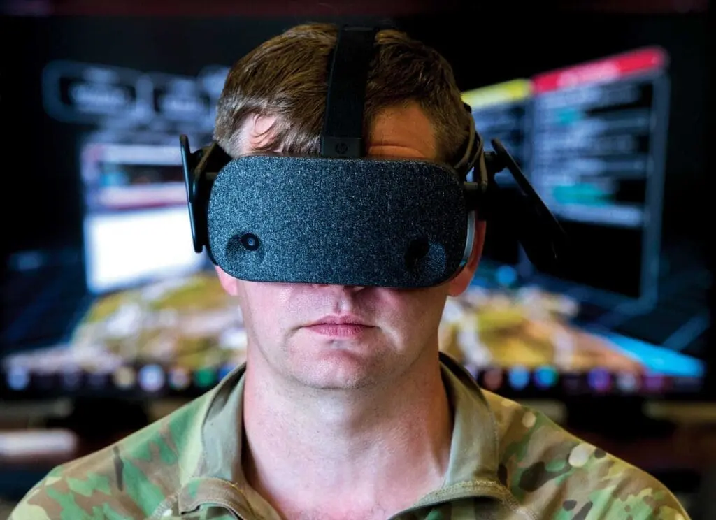 A man wearing a headset in front of a television.