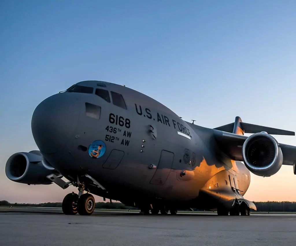 A large military plane sitting on top of an airport runway.