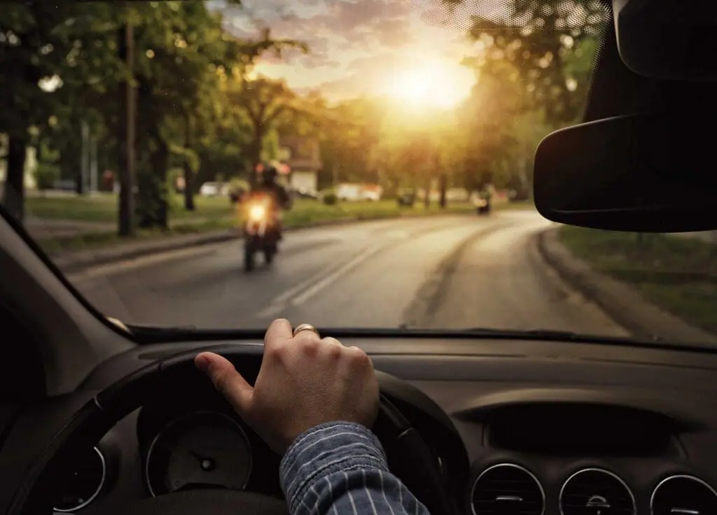 A person driving a car on the street