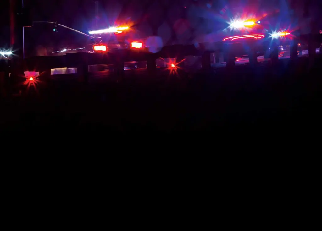 A blurry picture of some lights on the side of a road.