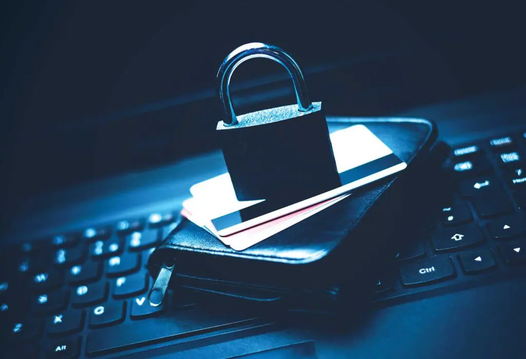 A padlock sitting on top of some credit cards.