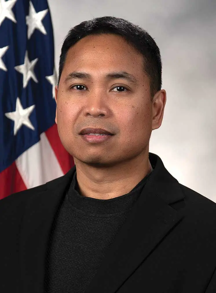 A man in black jacket and american flag.