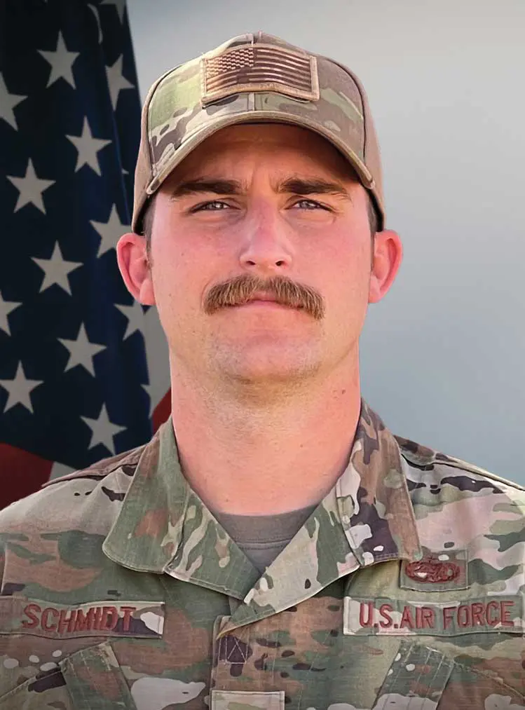 A man in military fatigues and a hat.