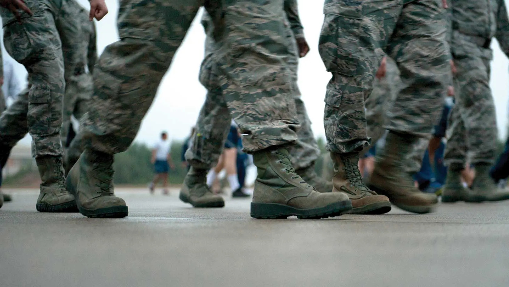A close up of some soldiers walking on concrete