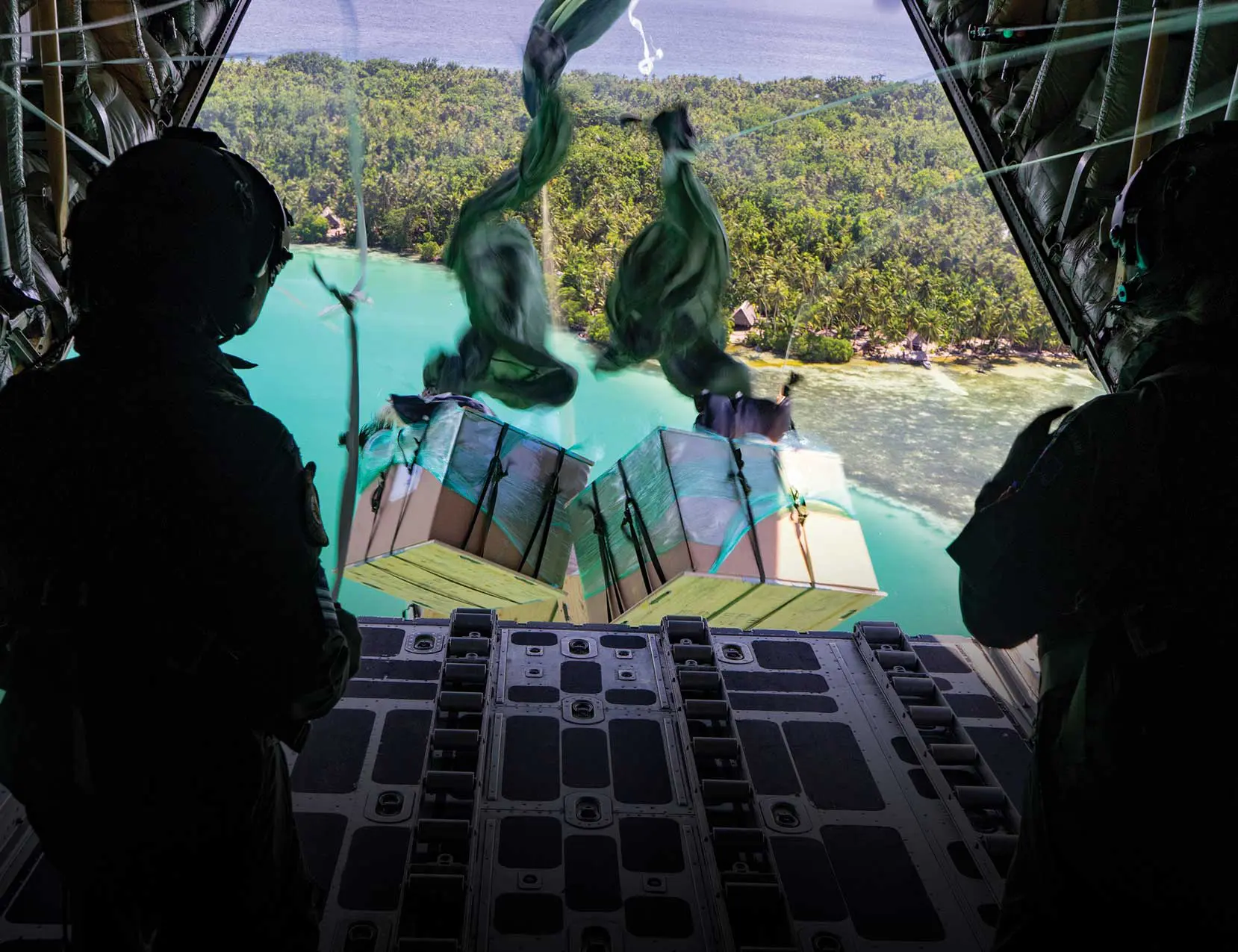 A view of the ocean from inside an airplane.