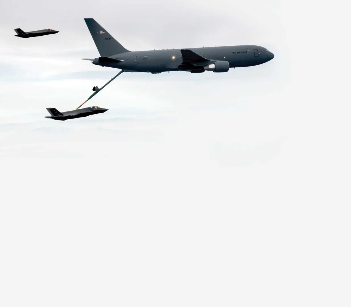 A plane is flying in the sky with another plane.