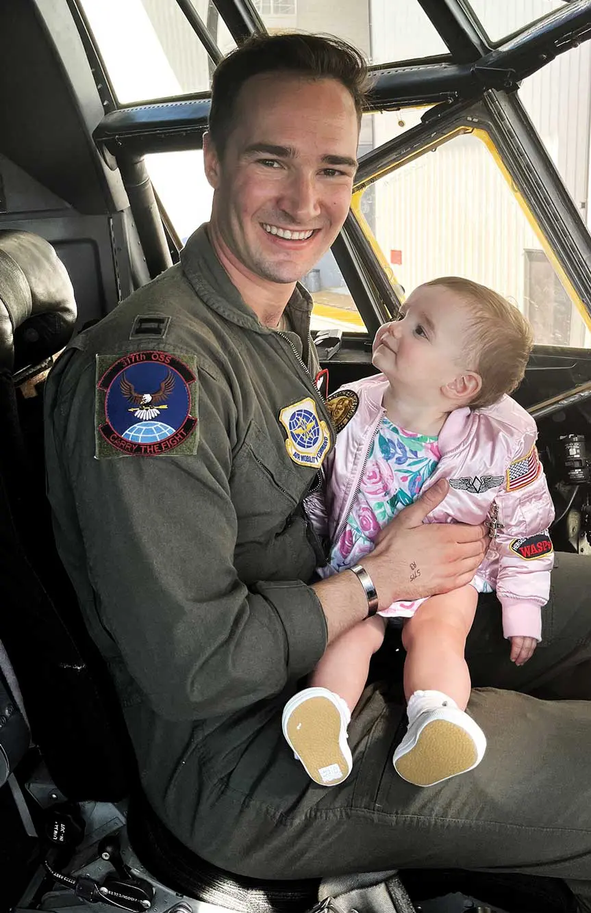 A man holding a baby in his arms.