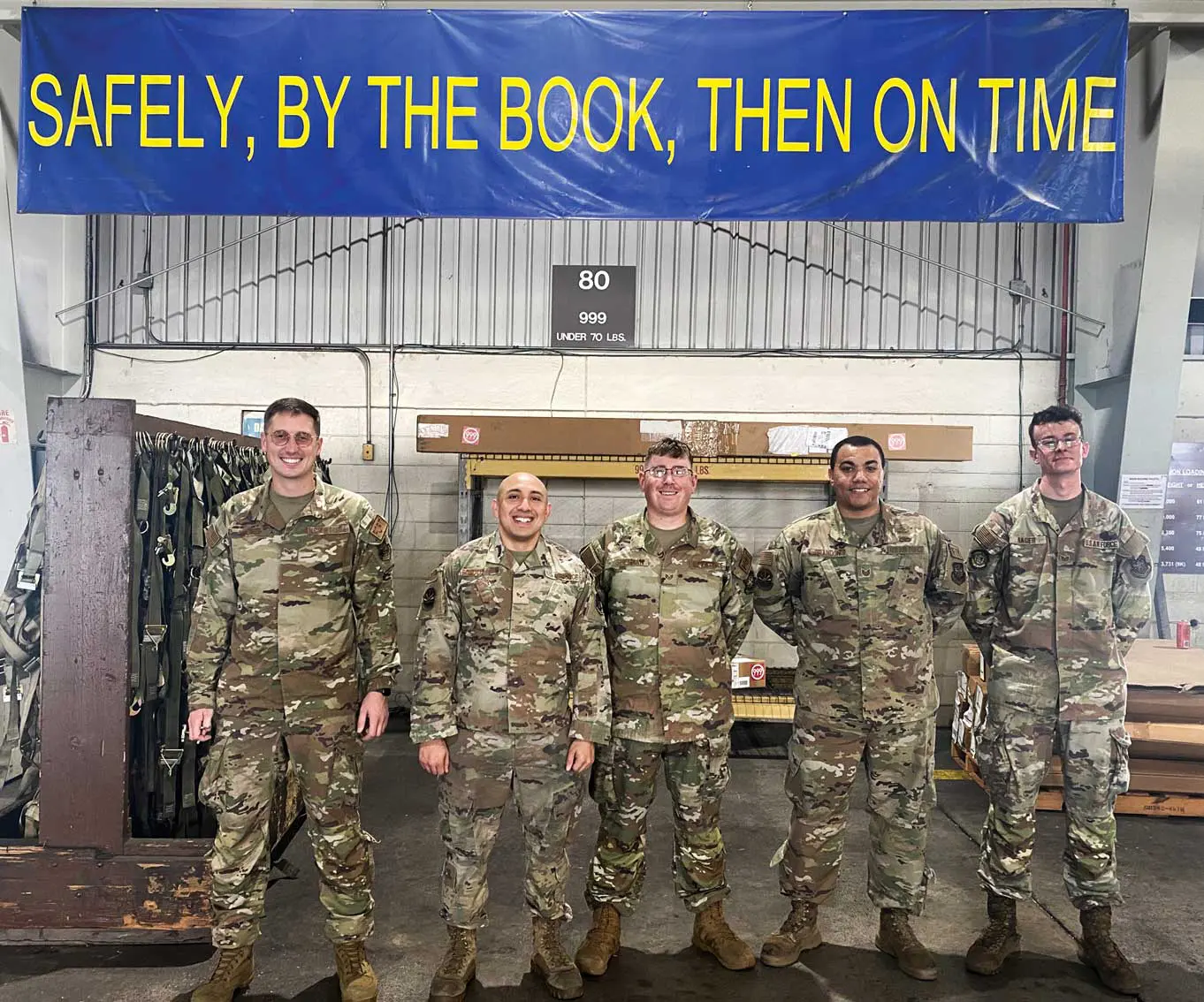 A group of soldiers standing in front of a sign.