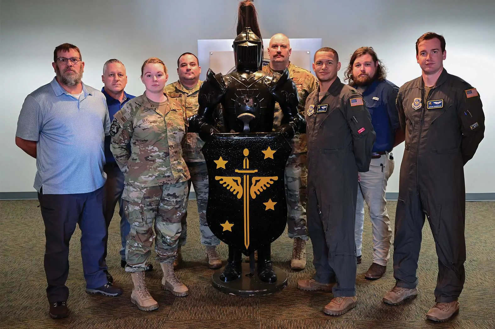 A group of people standing around a statue.