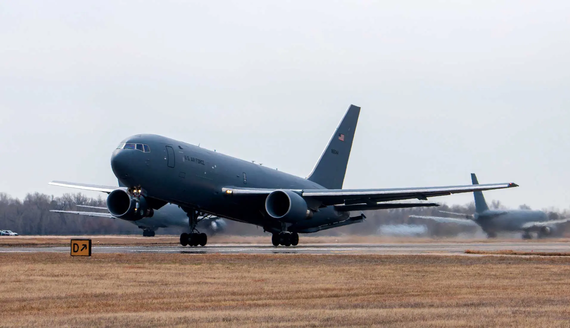 A large jet airplane on the runway of an airport.