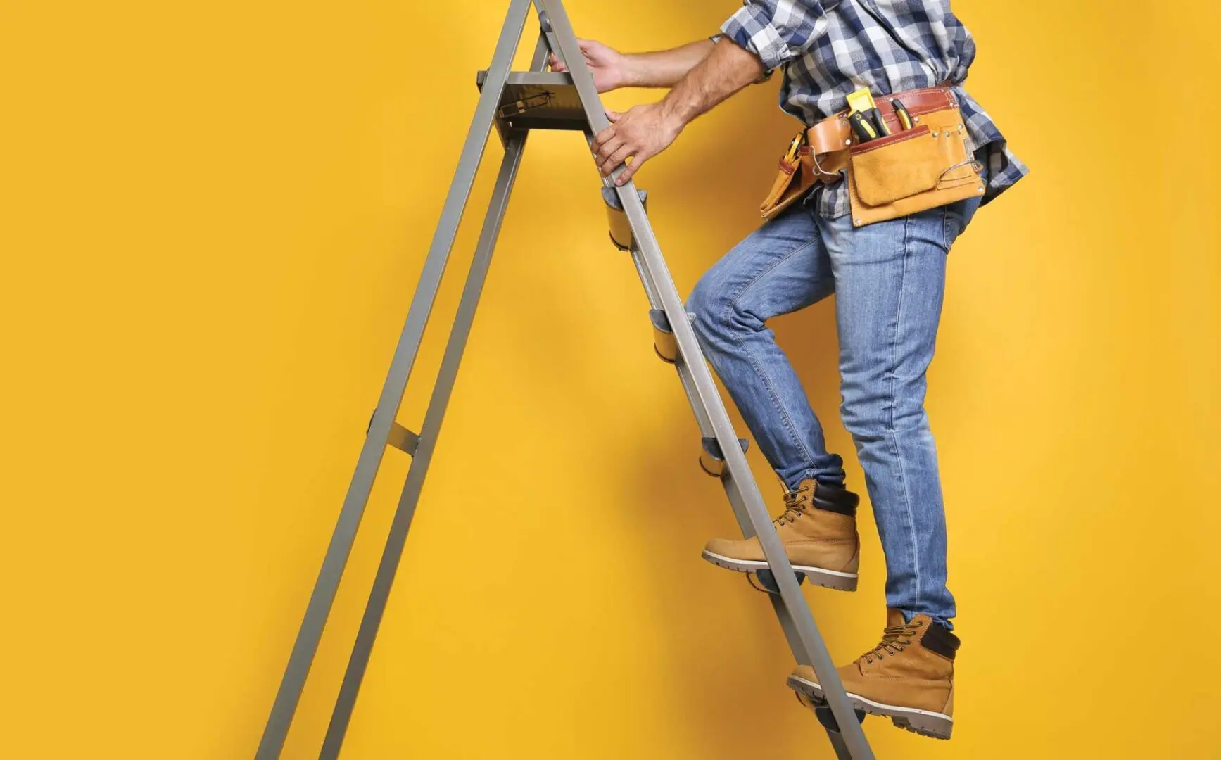 A man standing on the side of a ladder.