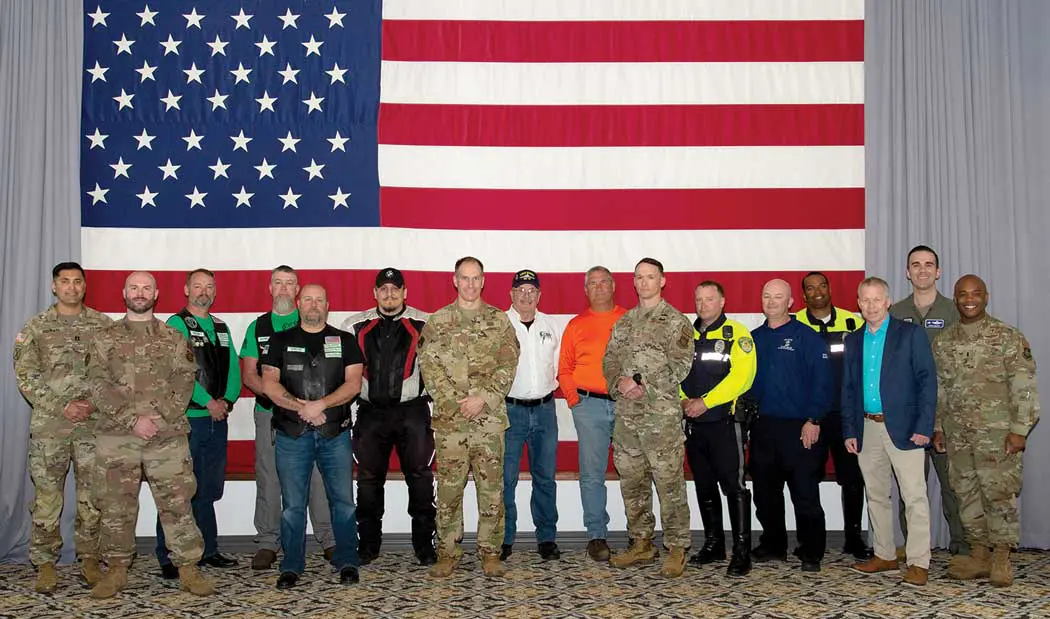 A group of people standing in front of an american flag.