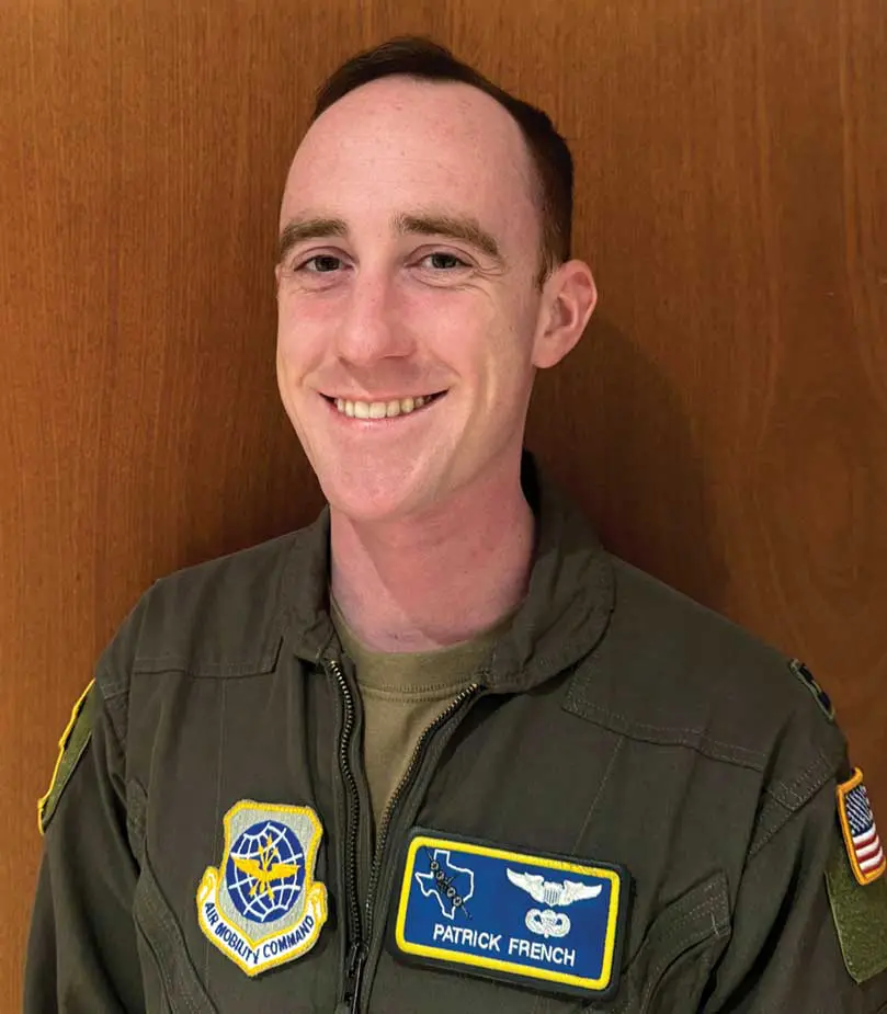 A man in an air force uniform smiling.