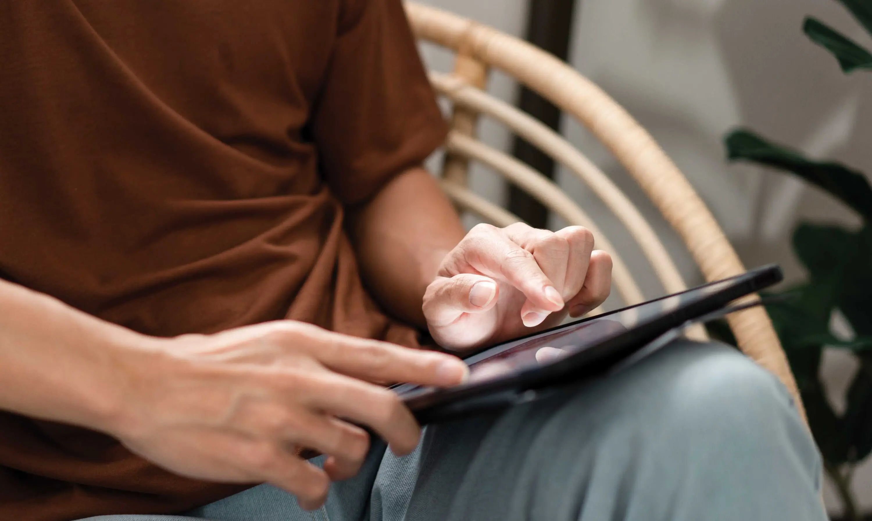 Person sitting using an iPad.