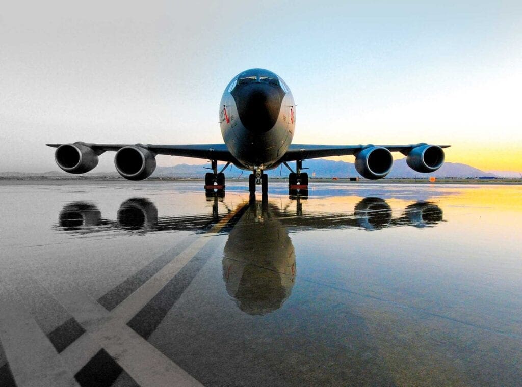 A large jet airplane on the tarmac with its wheels down.