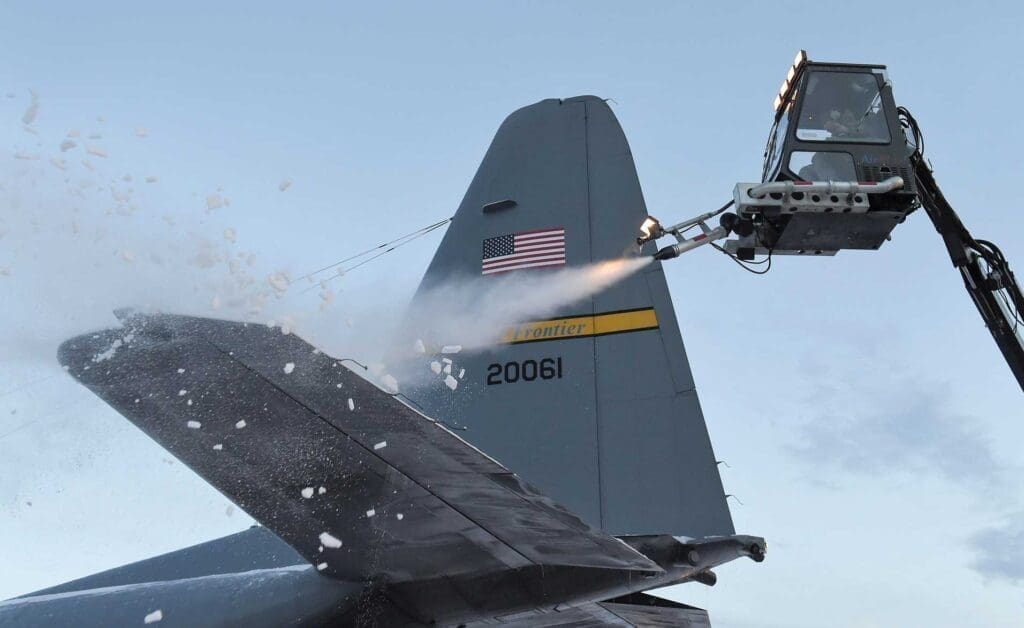 A jet fighter plane being sprayed with water.