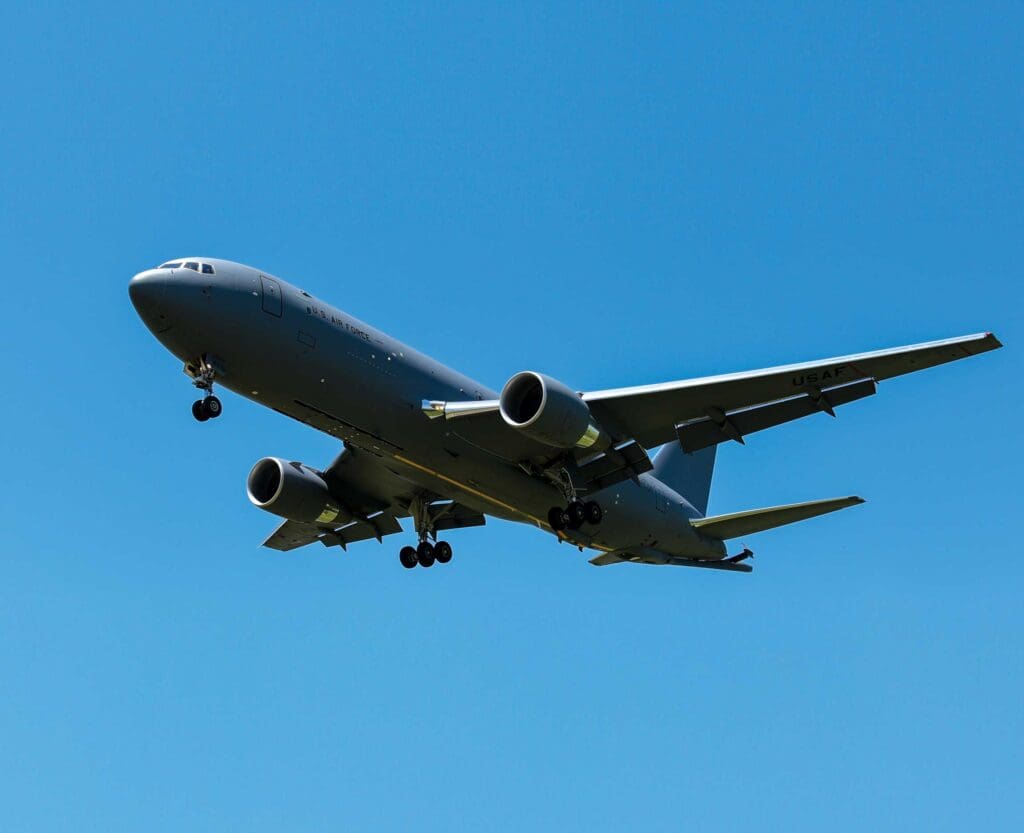A large airplane flying in the sky on a clear day.