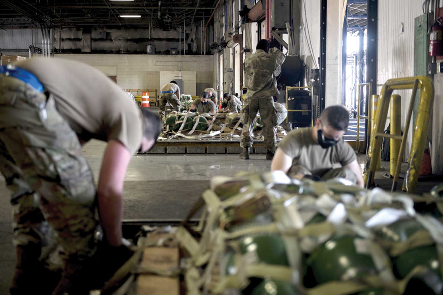 A group of men working in a warehouse.