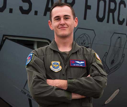 A man in military uniform standing with his arms crossed.