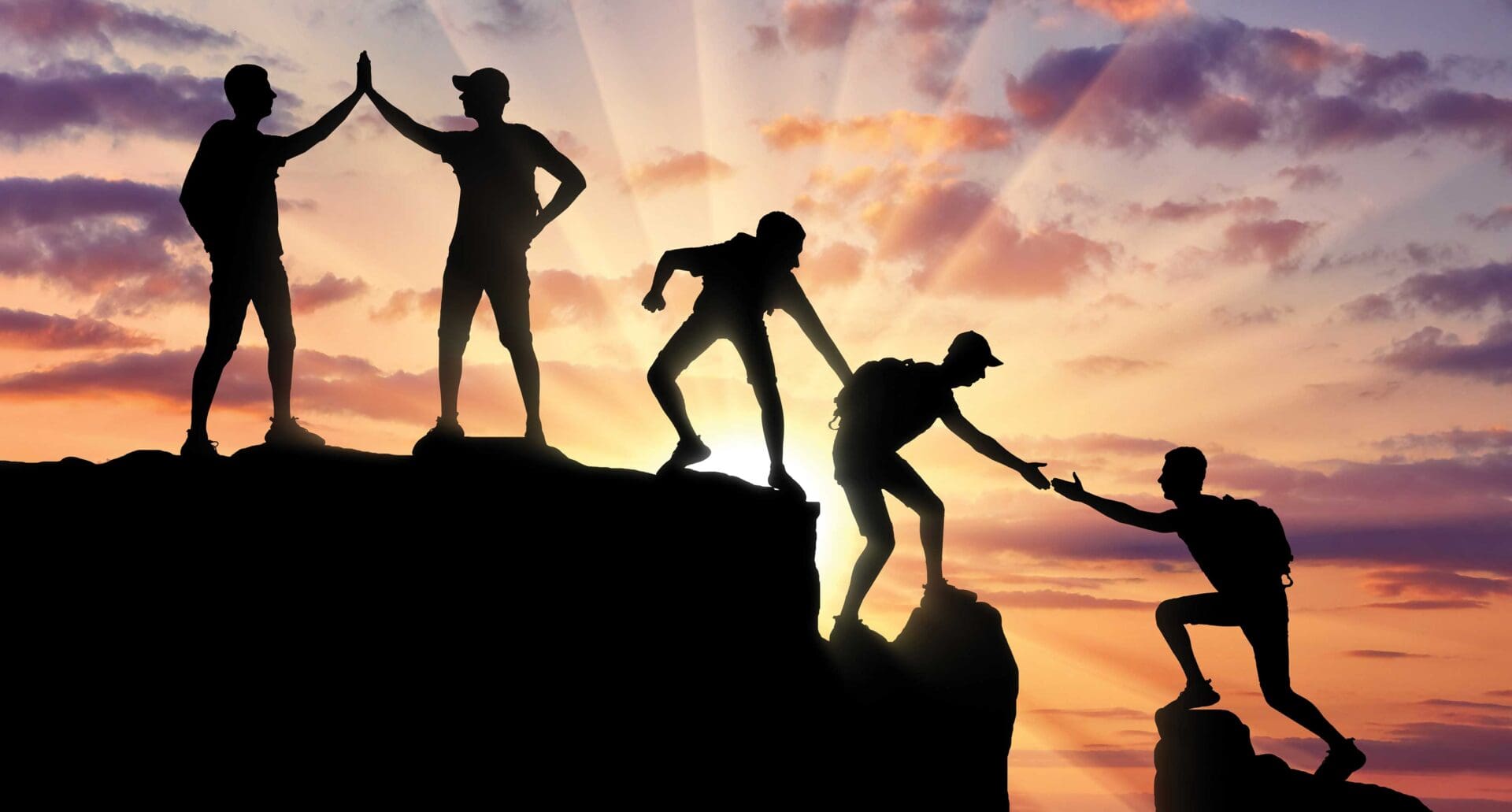 A group of people standing on top of a mountain.