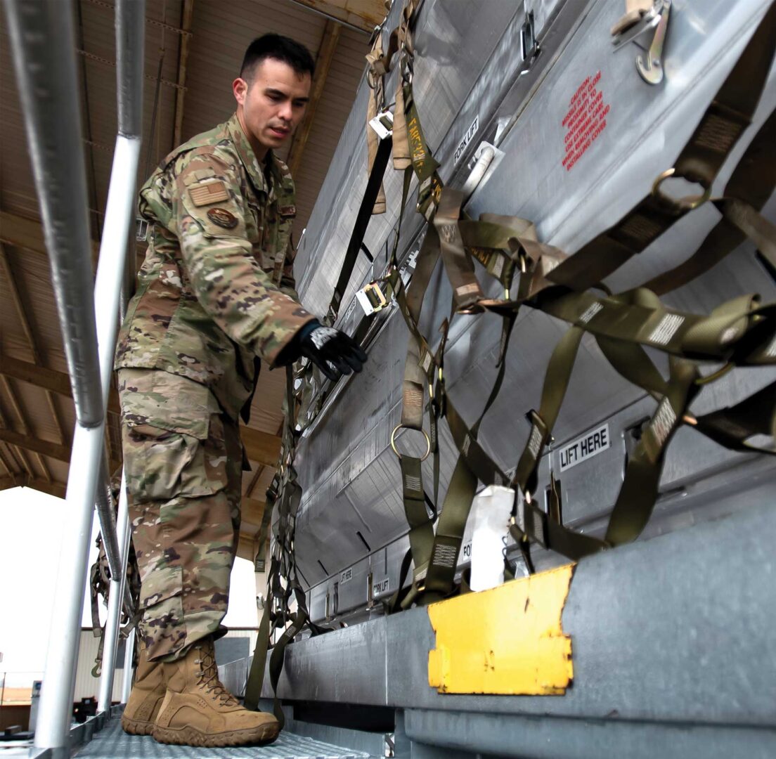 SSgt Rafael DeGuzman-Paniagua, 305th Aerial Port Squadron Special Handling Representative, secures a pallet of equipment on Joint Base McGuire-Dix-Lakehurst, NJ, March 24, 2022. The 305th Air Mobility Wing is sending equipment to Europe as part of the United States security assistance to Ukraine. USAF photo by SrA Joseph Morales