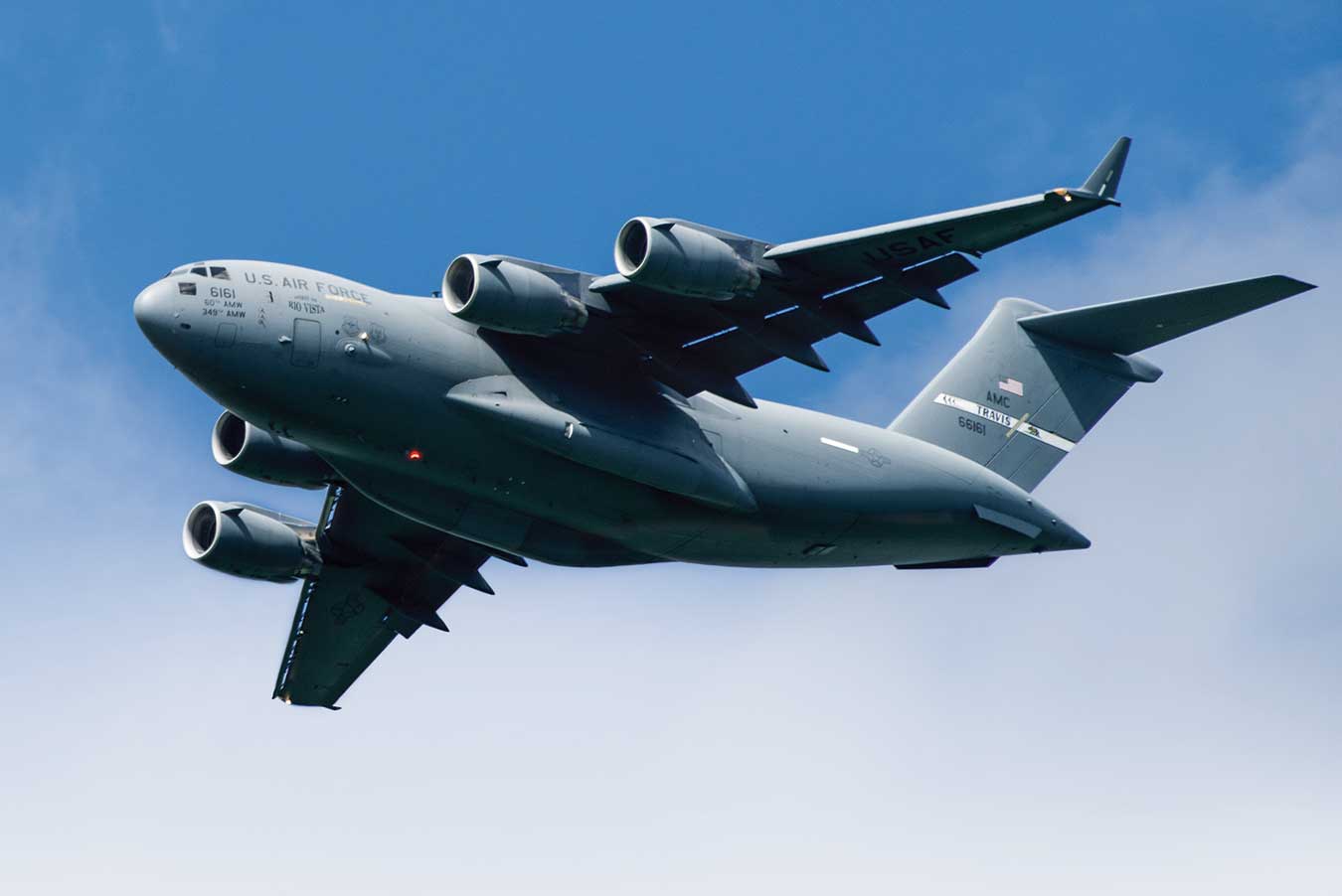 A large military plane flying through the sky.