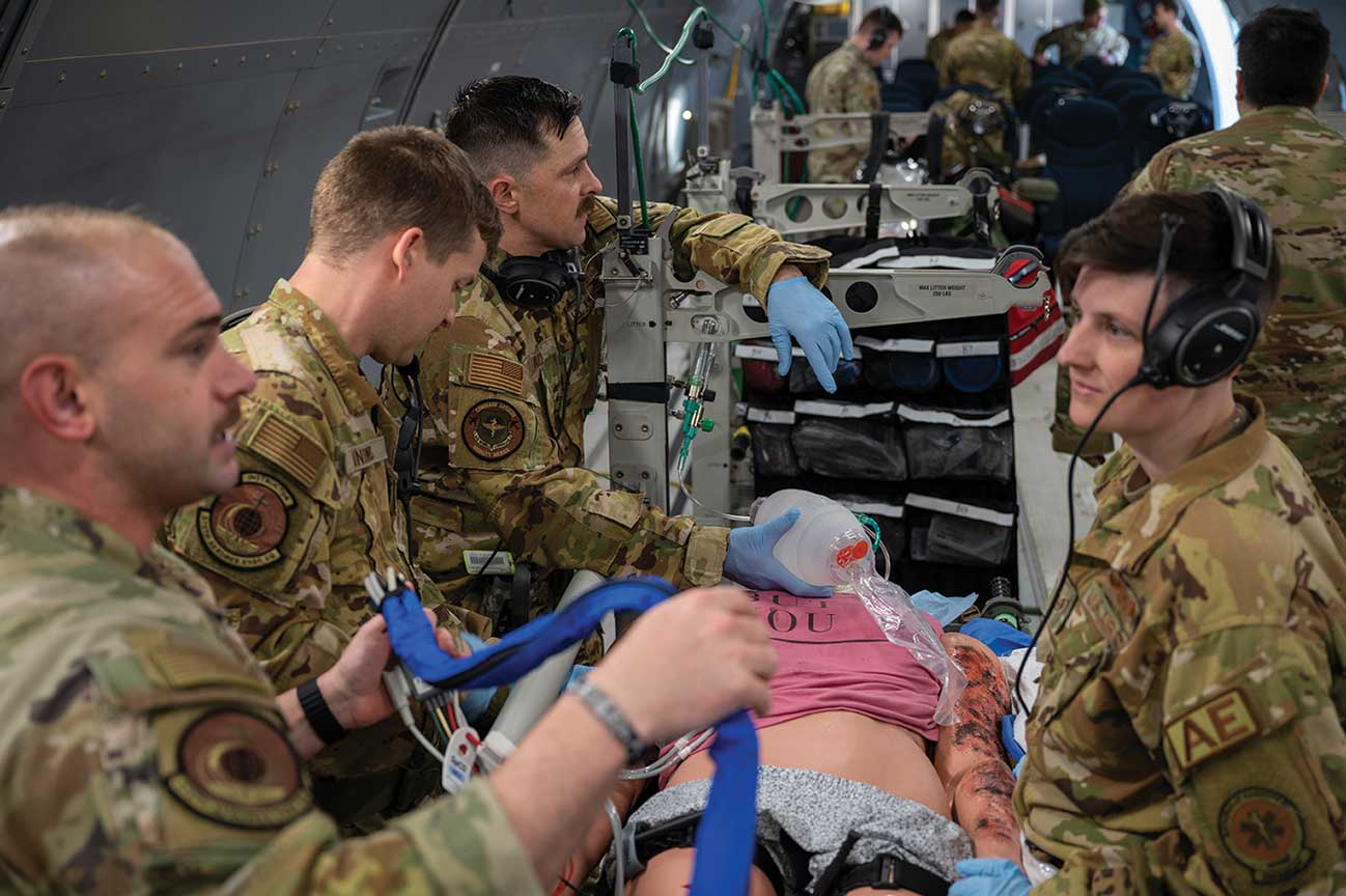 A group of soldiers are helping to treat an injured person.