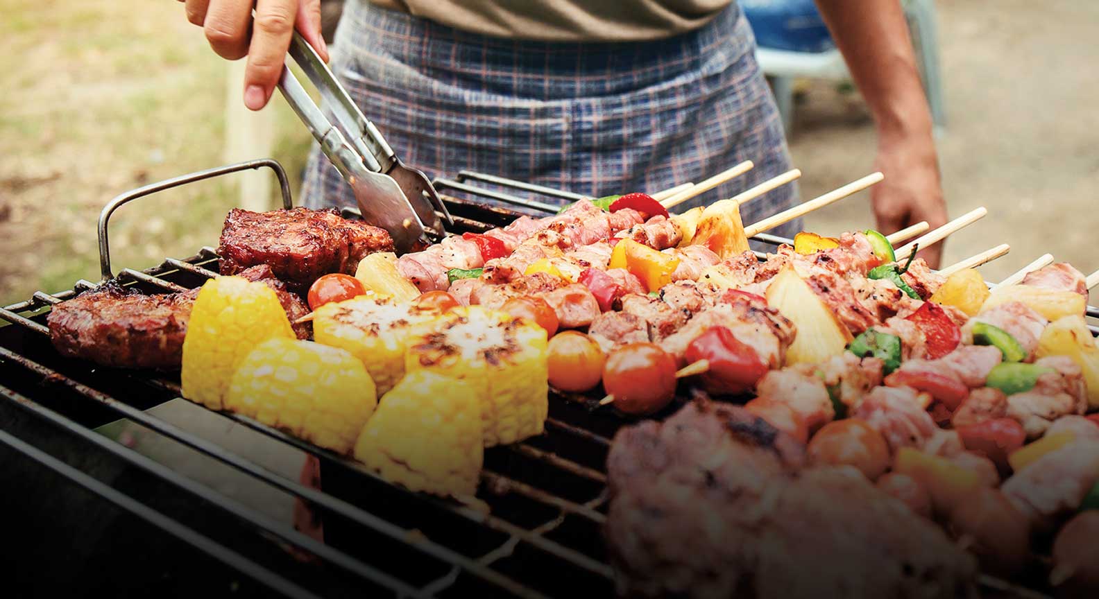 A person grilling food on top of a grill.