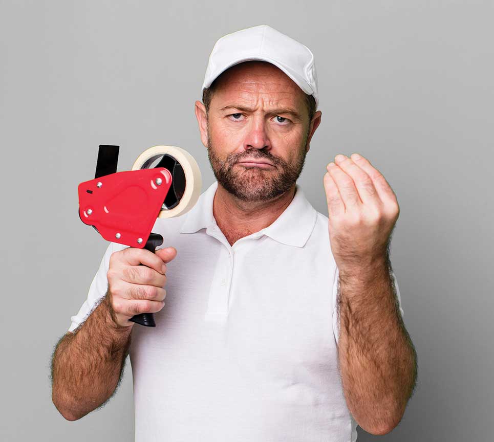 A man holding an electrical tape gun in his hand.