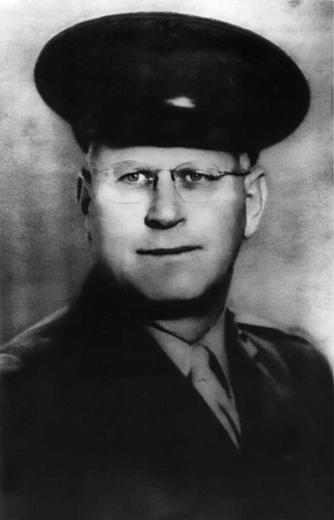 A black and white photo of an older man wearing glasses.