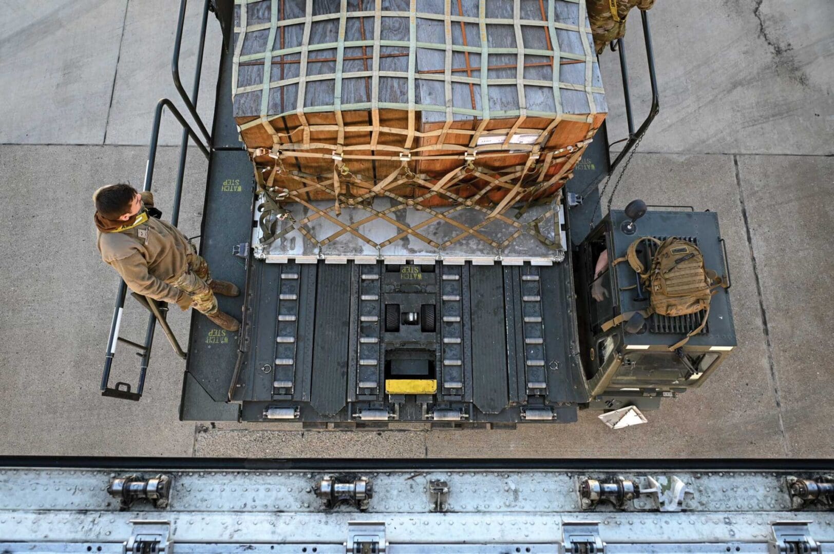 A cargo area with military equipment and a cage.