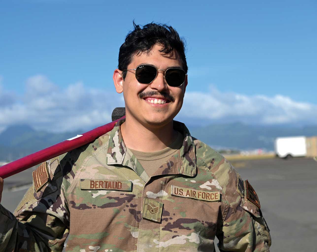 A man in military fatigues and sunglasses.