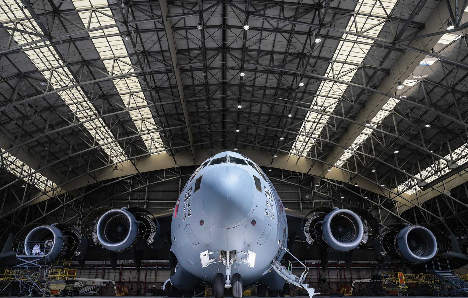A large airplane inside of an airport hangar.