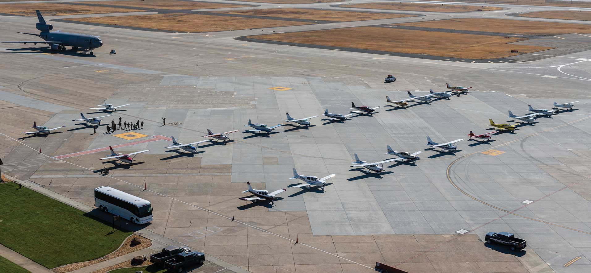 A group of airplanes parked on top of an airport runway.