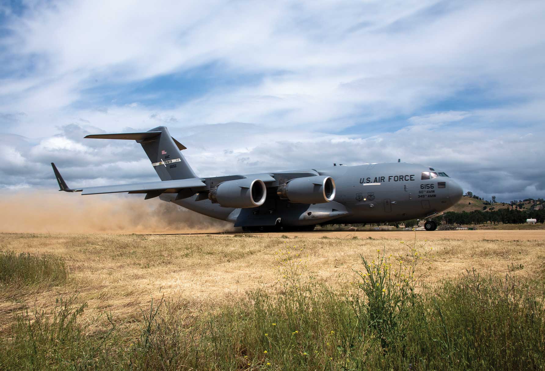 A C-17 Globemaster III participating in Exercise Golden Phoenix takes off on a dirt runway at Schoonover Airfield, CA, May 9, 2023. Golden Phoenix is a large-scale readiness exercise hosted by Travis Air Force Base with full spectrum support from partner units.