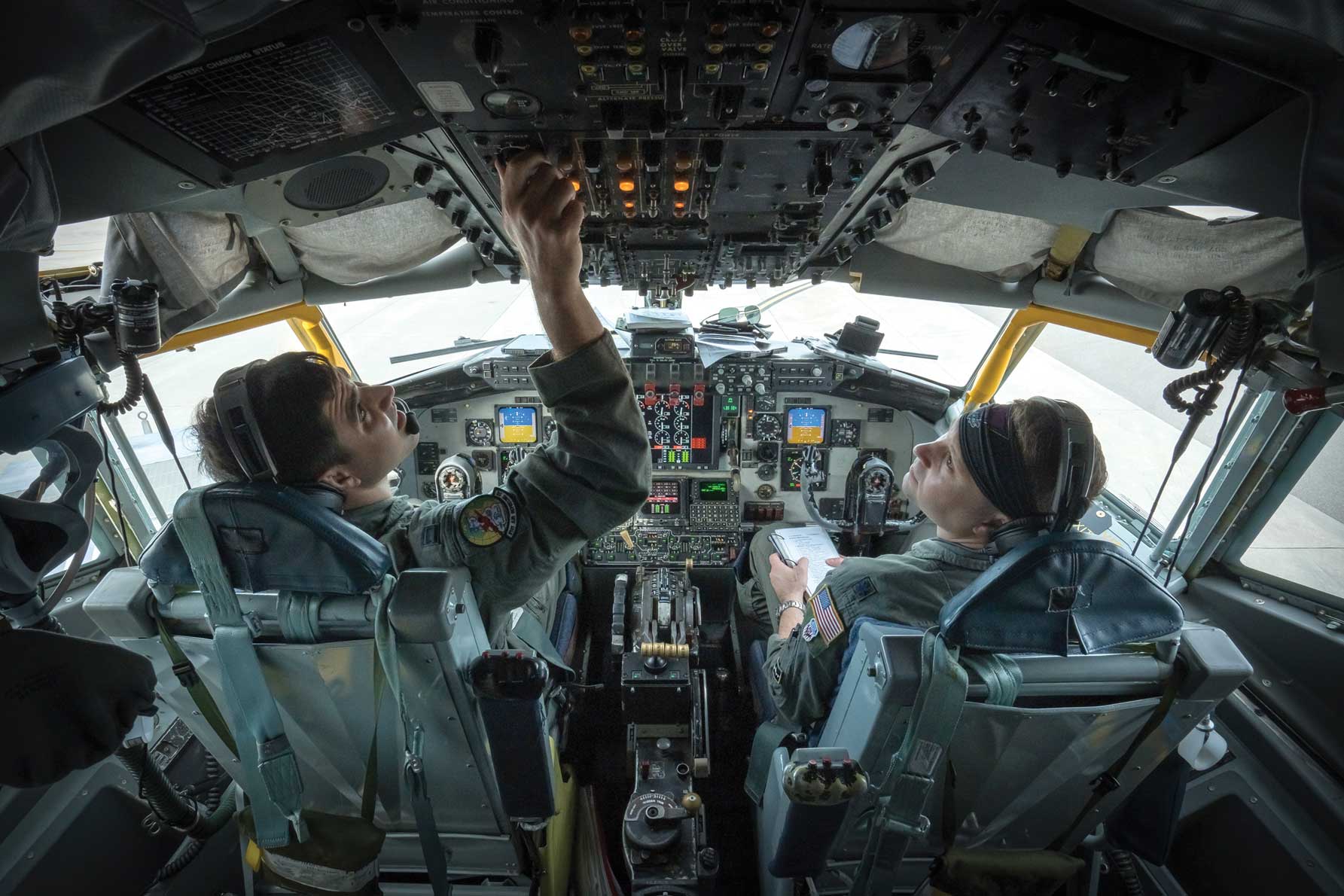 Two pilots in the cockpit of a plane