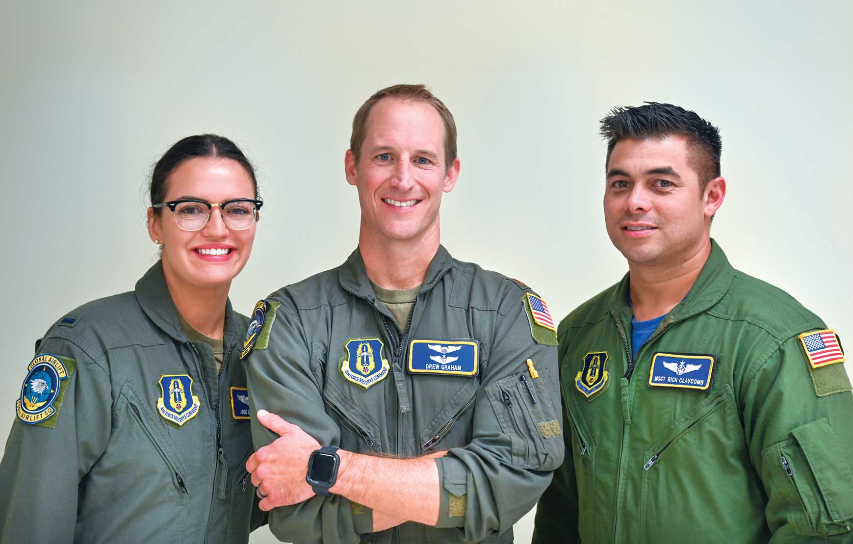 Three people in military uniforms posing for a picture.