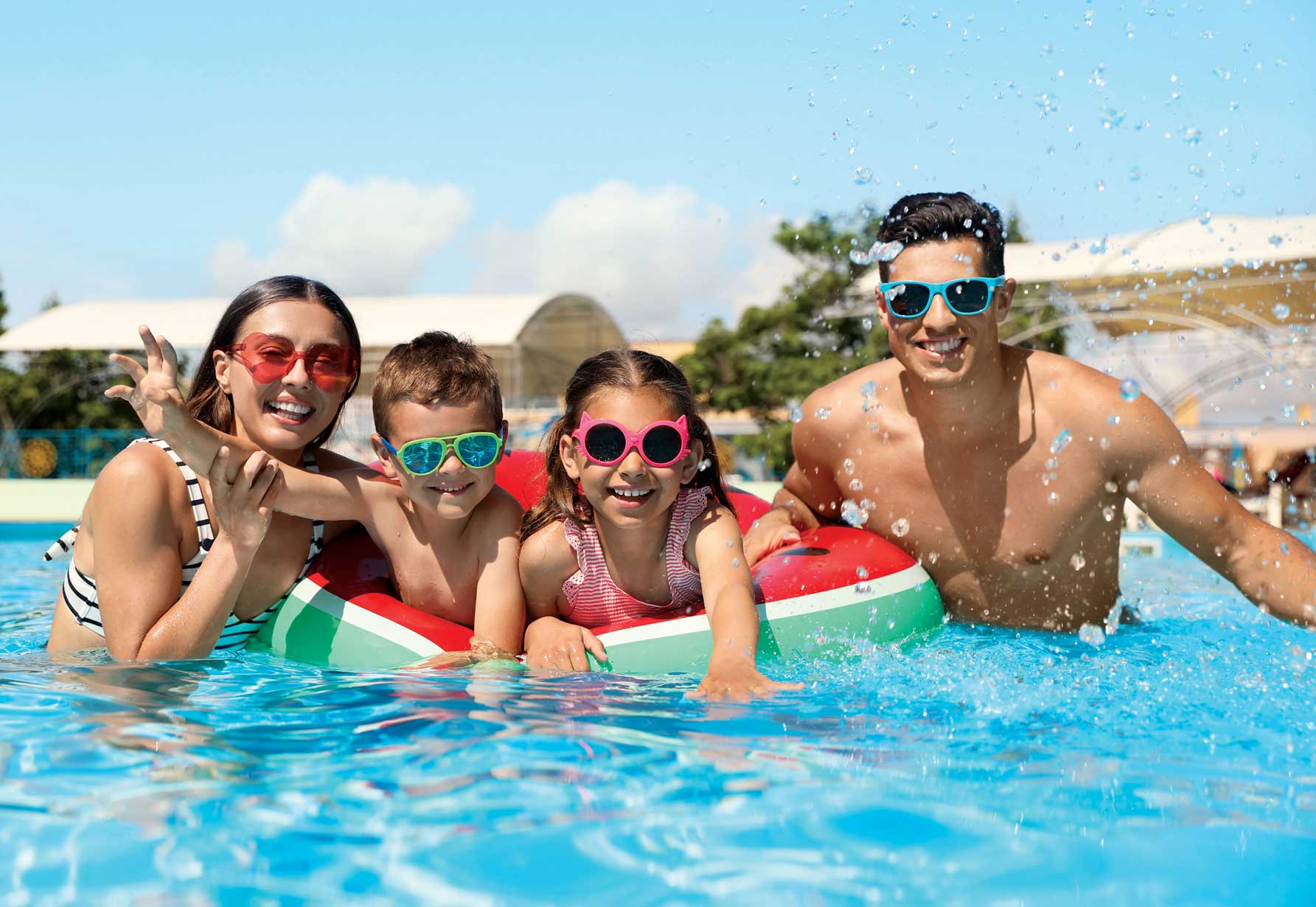 A family is swimming in the pool together.