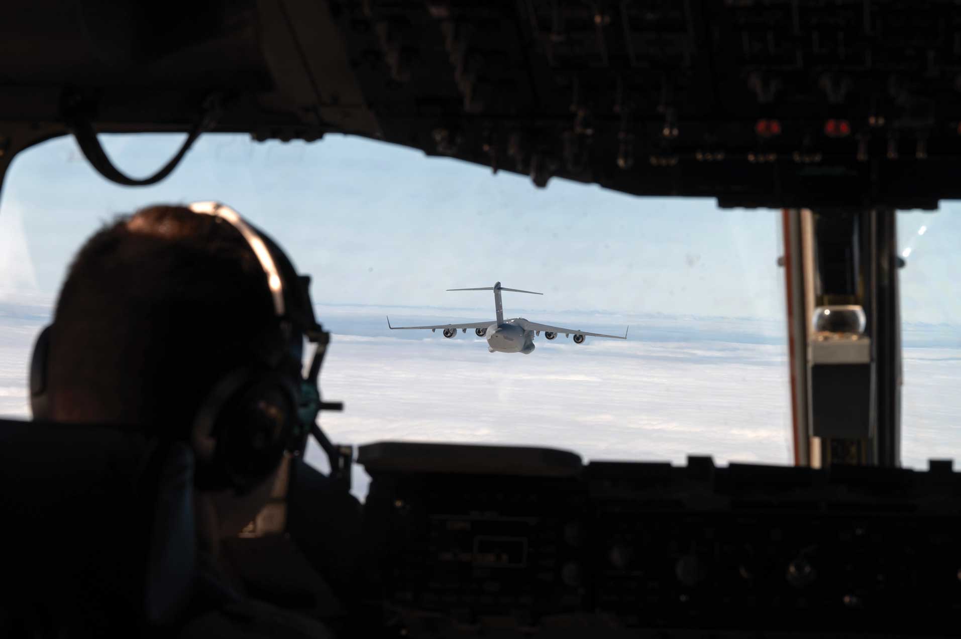 Two C-17 Globemaster IIIs trade leading and following positions within their flight path during the Tactics Advancement Course at Joint Base McGuire-Dix-Lakehurst, NJ, Feb. 7, 2024. USAF photo by A1C Aidan Thompson