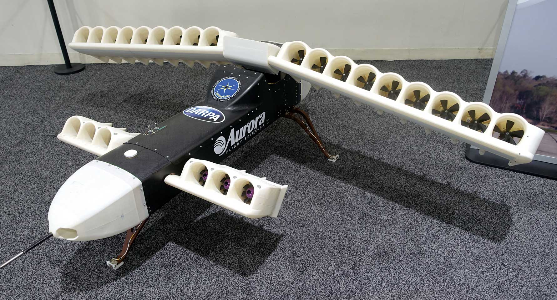 Example of distributed electric propulsion in an exhibit at the Defense Advanced Research Projects Agency’s D60 Symposium. The Aurora XV-24 LightningStrike is an experimental unmanned aerial vehicle created by Aurora Flight Sciences and partners Rolls-Royce and Honeywell. Photo by Daderot