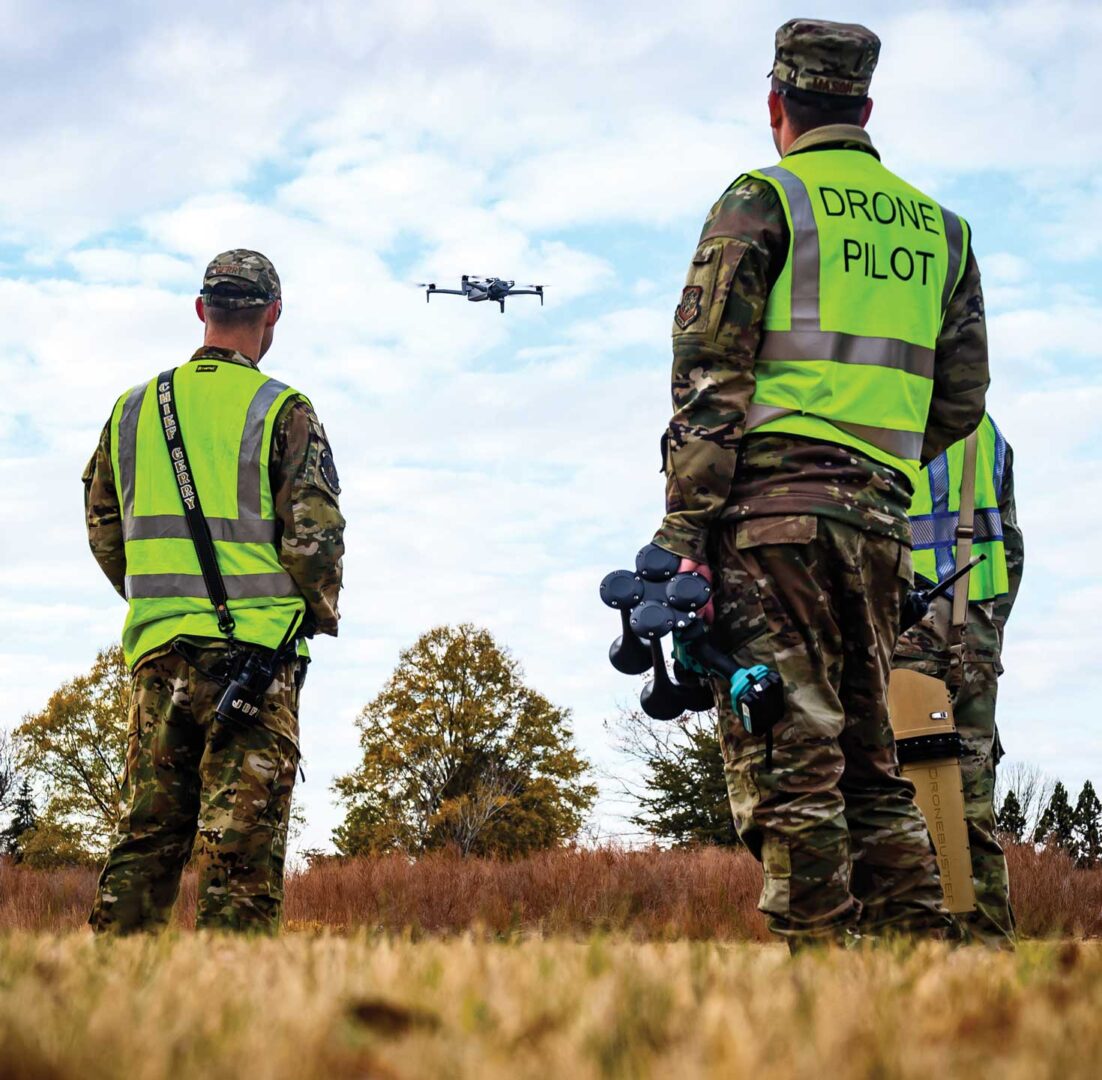 TSgt Robert Gerry, MSgt Brett Mason, and TSgt Christopher Anderson observe an sUAS vehicle exercise.