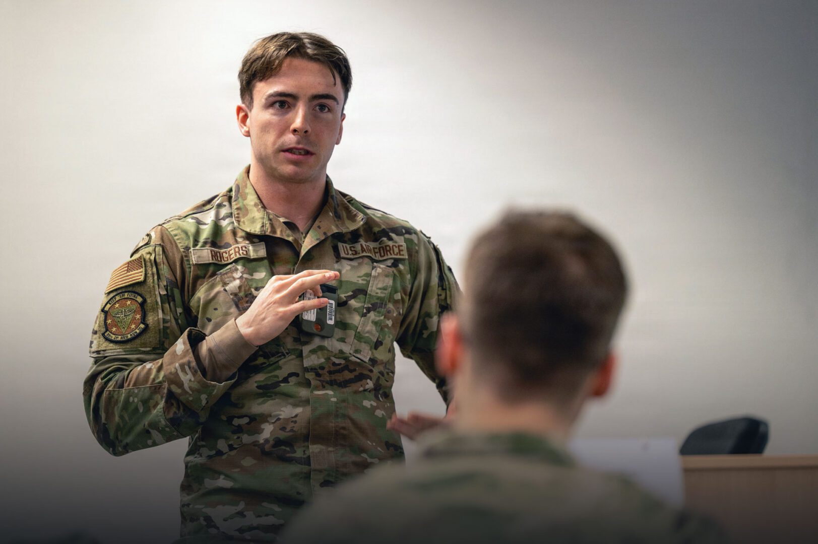 SrA Devin Rogers, 86th Operational Medical Readiness Squadron Readiness Non-Commissioned Officer in Charge, discusses his proposed decontamination and response procedures with the participants of exercise Radiant Falcon at Ramstein Air Base, Germany.